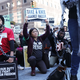 A coalition of advocacy groups “take a knee” outside a hotel where quarterly NFL league meetings are held Oct. 17, 2017, in New York City. (Spencer Platt/Getty Images)